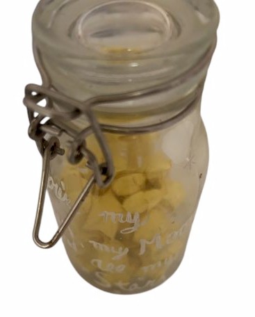 Glass jar of yellow star confetti